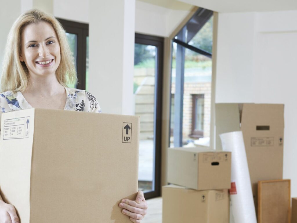 A woman carrying a moving box | Choice Moving Company